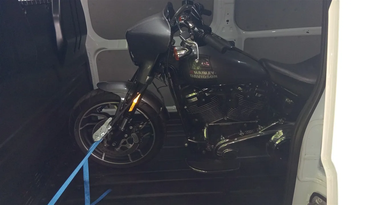 Grey Harley-Davidson motorcycle inside the transport van